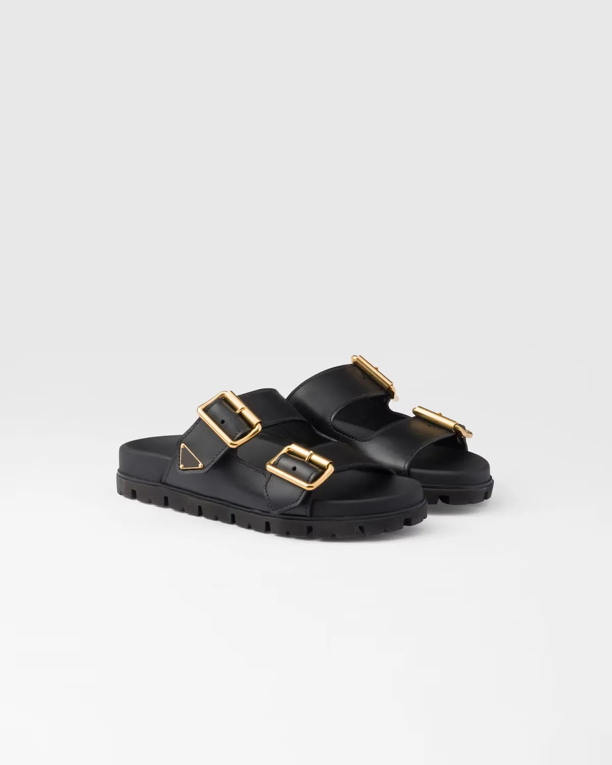 Zwarte slide sandalen met gouden gespen